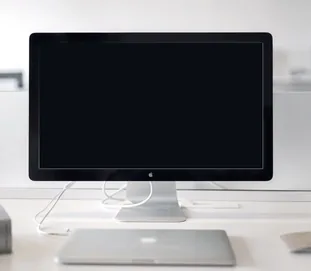 A desktop monitor on a studio desk